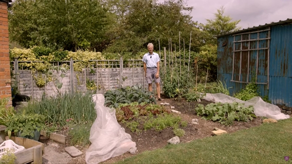 Charles standing in the small garden